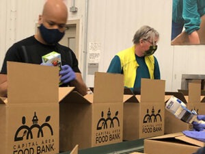 A Year Of Giving Back 12 Ways To Help In 2024 Capital Area Food Bank   Volunteer With Boxes Embed 300x225 